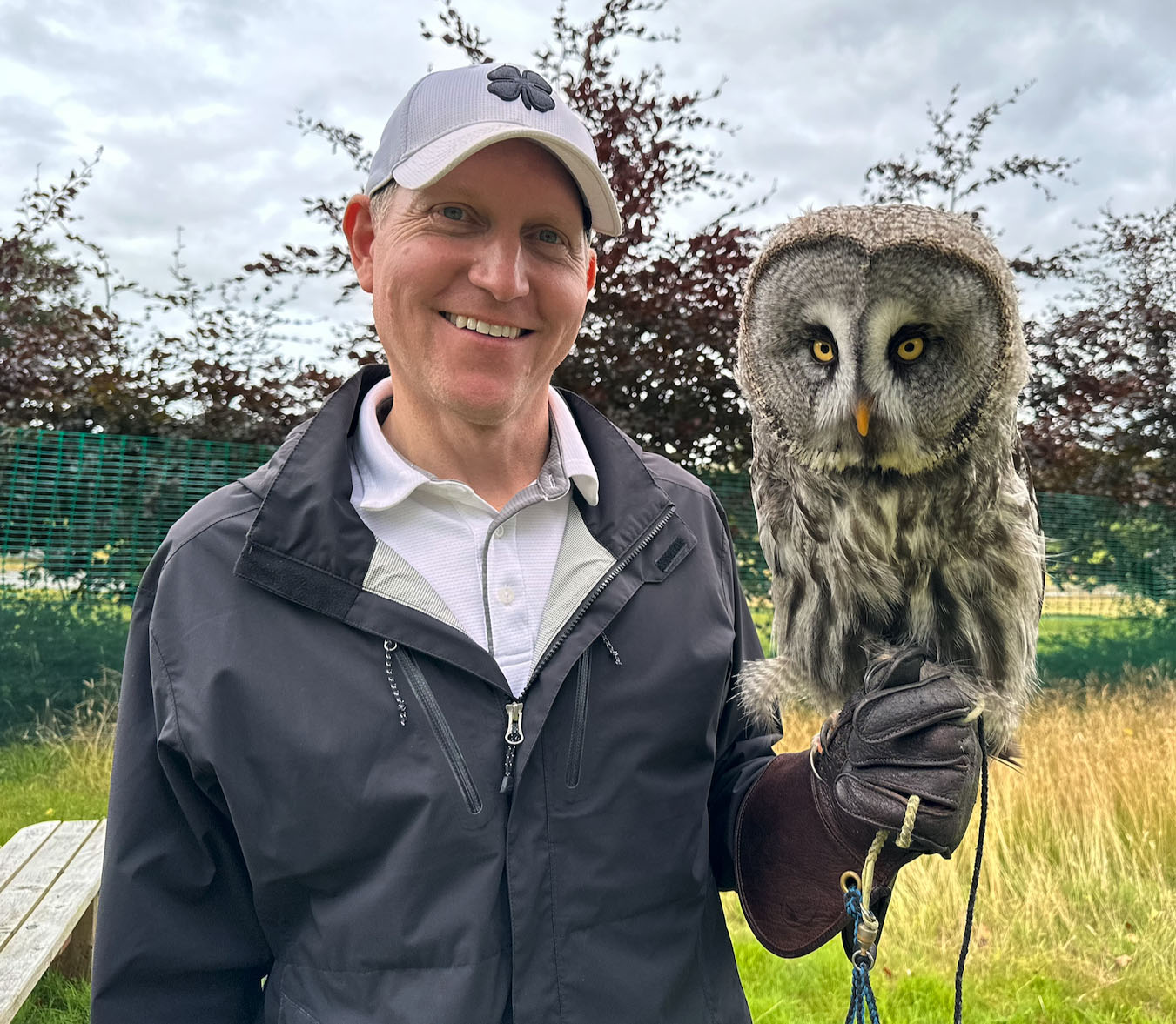 Dave Poortvliet holding a Great Gray Owl on a falconer's glove